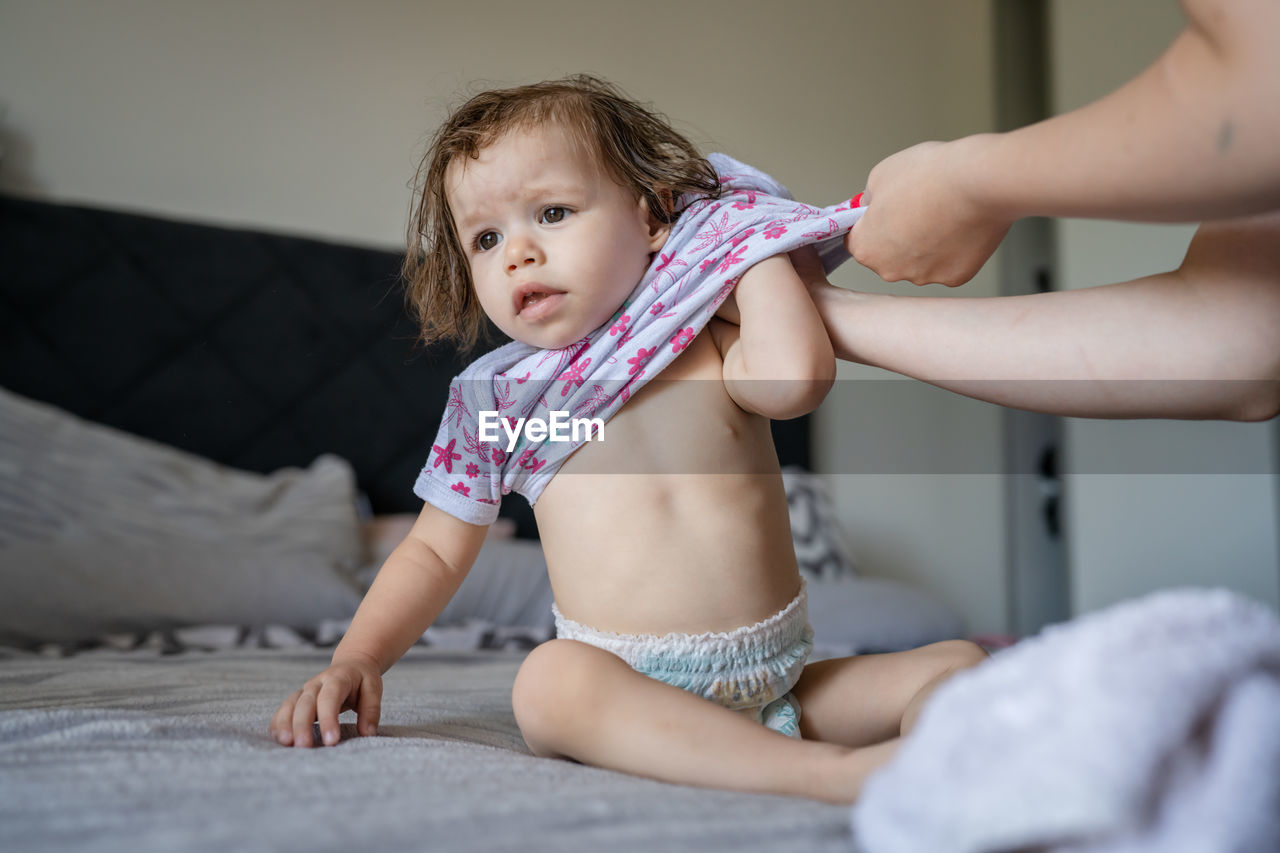 portrait of cute baby boy lying on bed