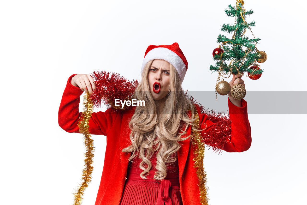 CHRISTMAS TREE IN FRONT OF RED AND WHITE BACKGROUND