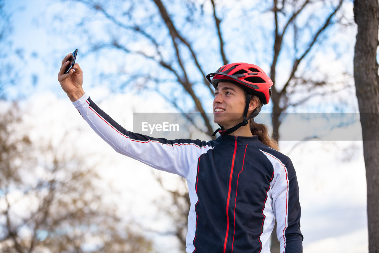 Male athlete taking selfie while standing park