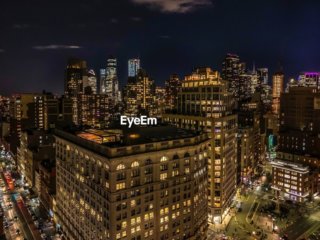 High angle view of illuminated buildings in city at night