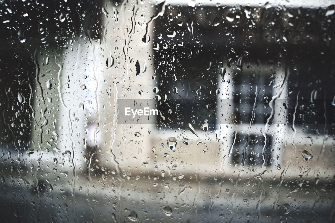 Waterdrops on glass against blurred background