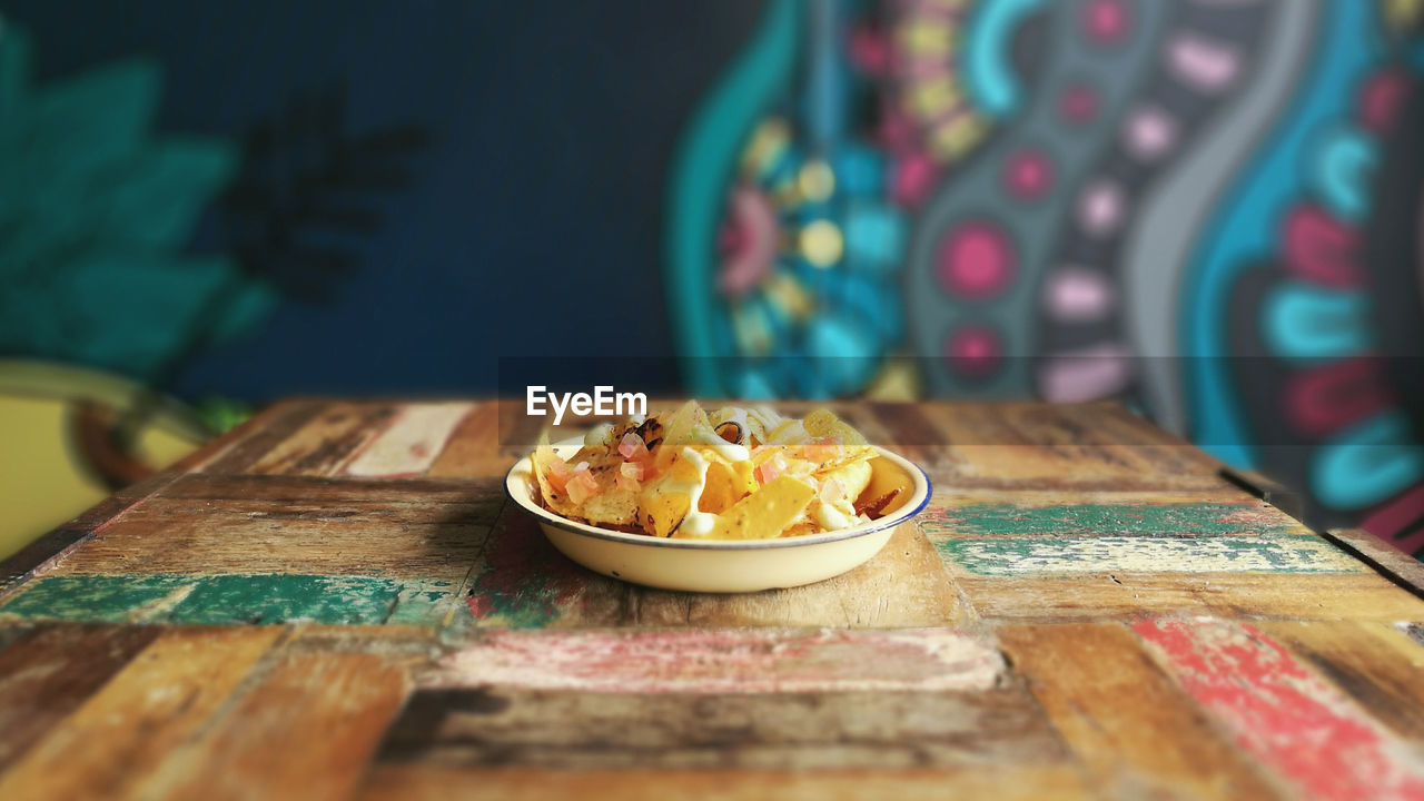 Close-up of dessert on table against wall