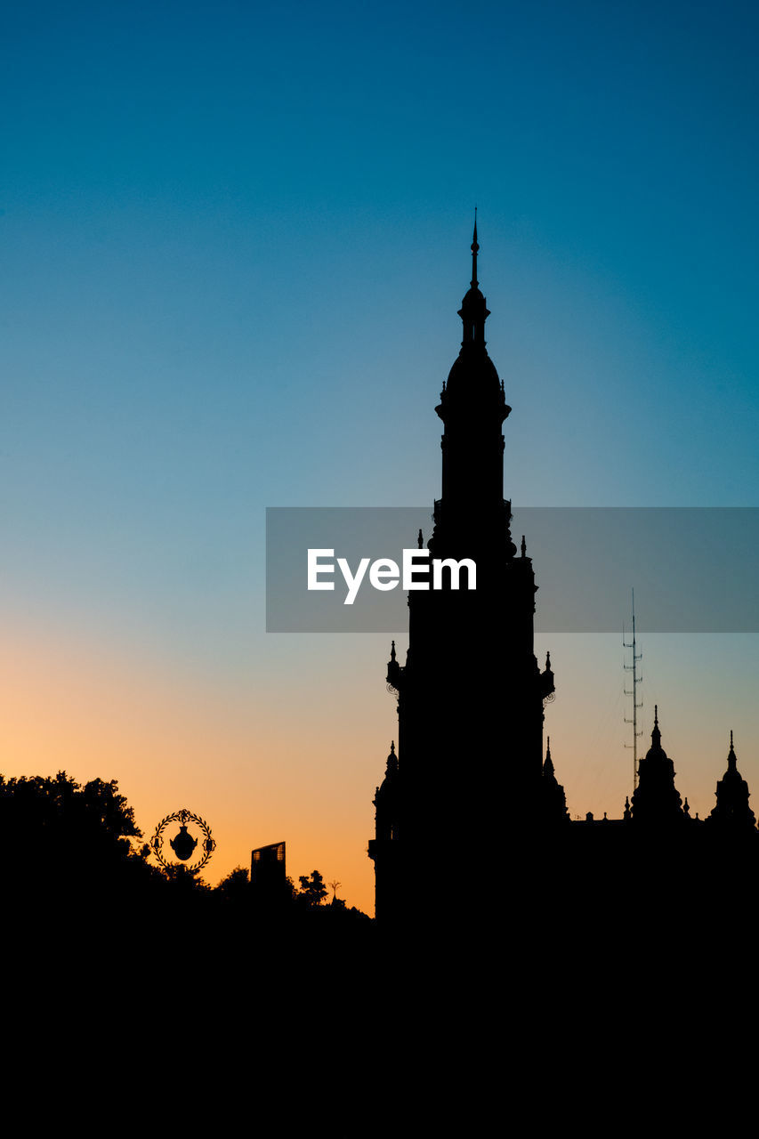 Silhouette of historic building against sky during sunset