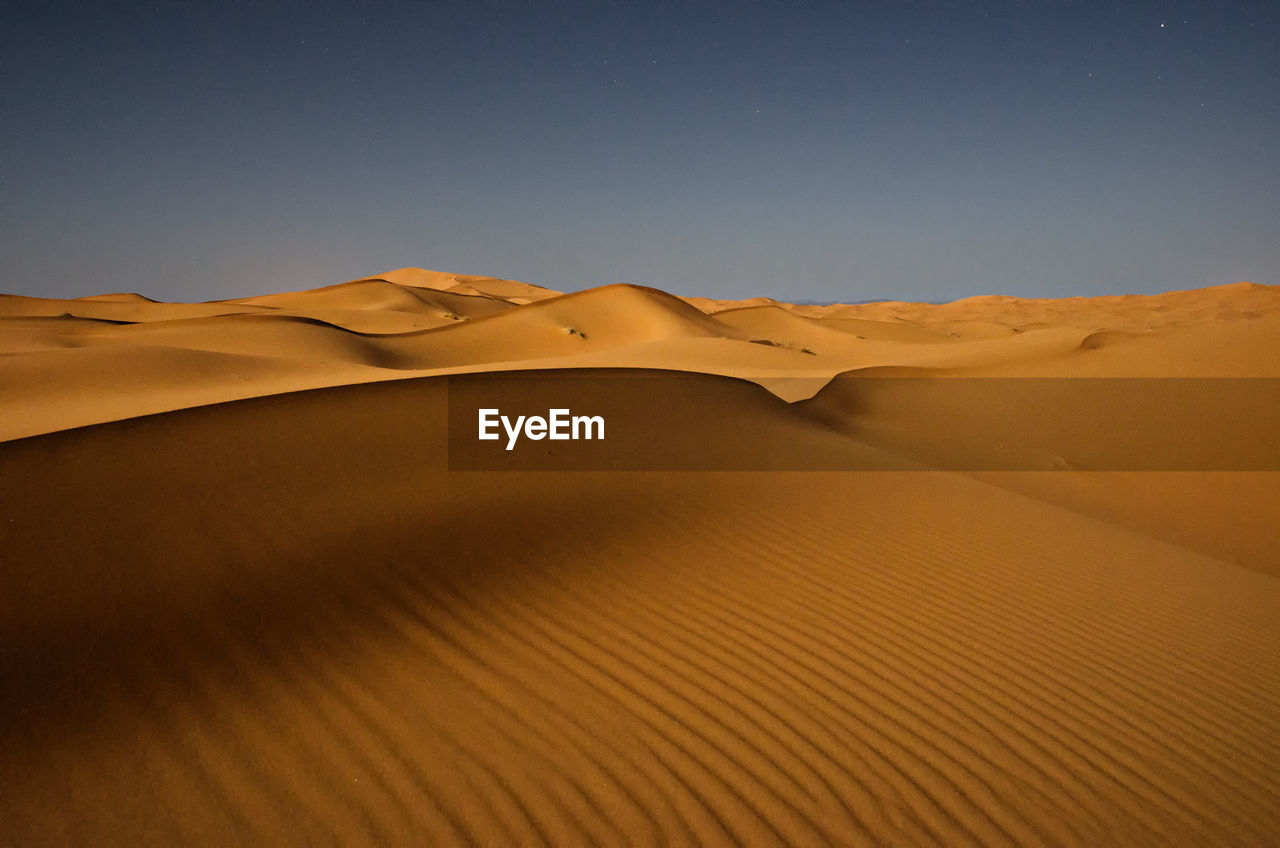 Scenic view of desert against clear sky