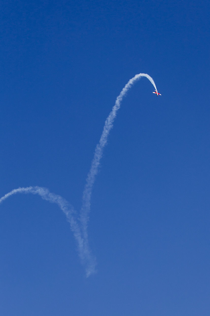 Low angle view of airplane flying against sky