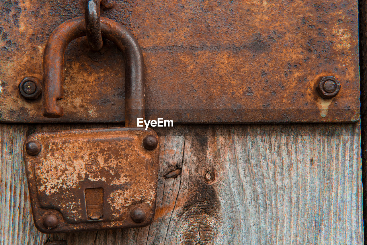 Close-up of padlock on closed door