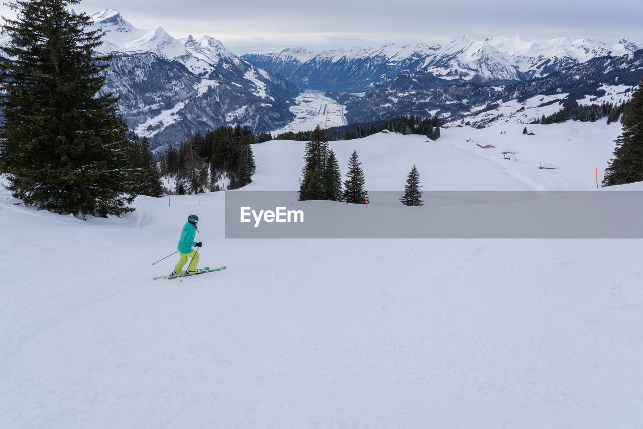 Full length of man skiing on snowcapped mountain