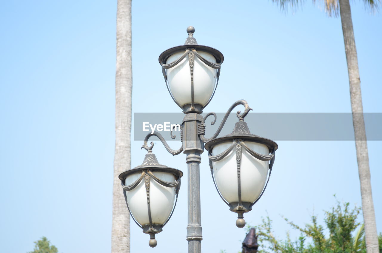 LOW ANGLE VIEW OF LAMP AGAINST STREET LIGHT AGAINST SKY