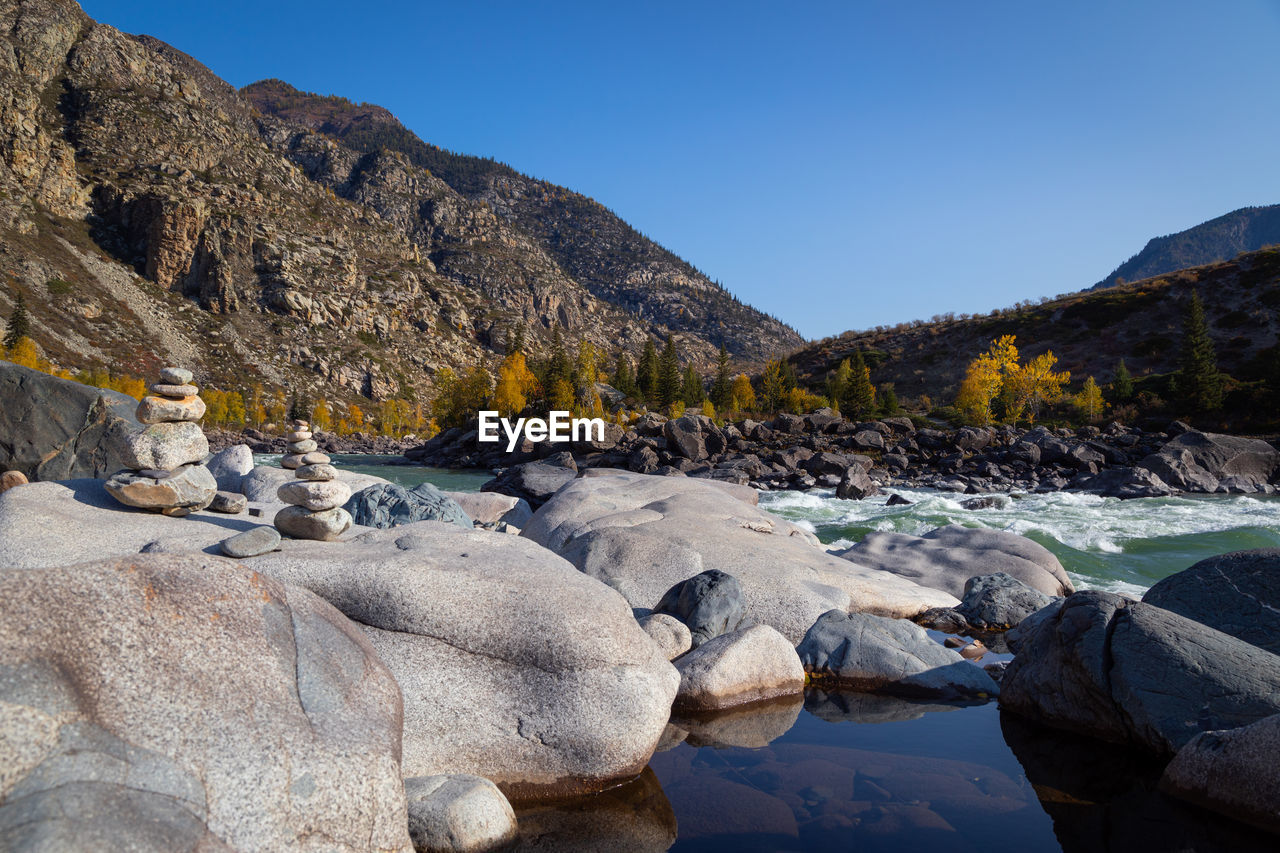 ROCKS IN RIVER AGAINST SKY