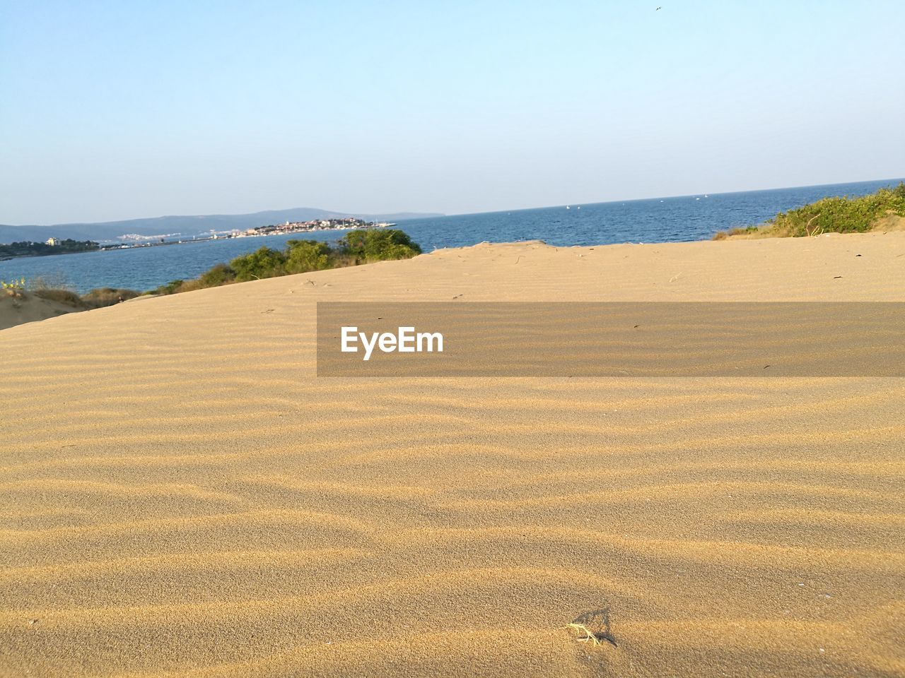 Scenic view of beach against blue sky