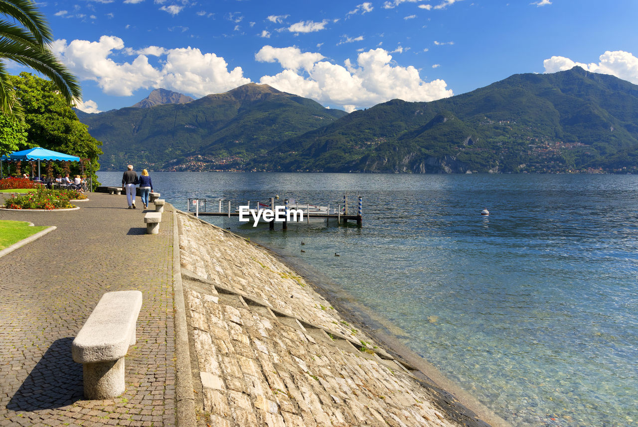 View of calm sea against mountain range