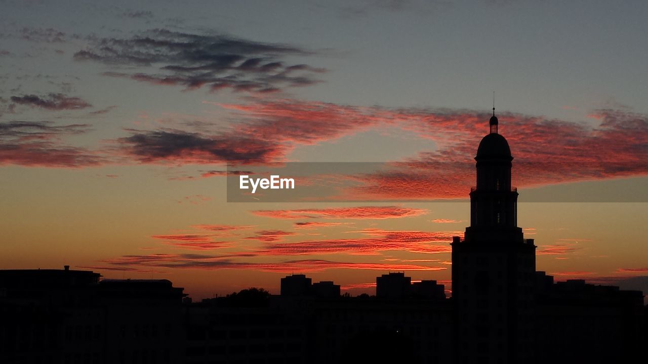 Silhouette of church and skyscrapers