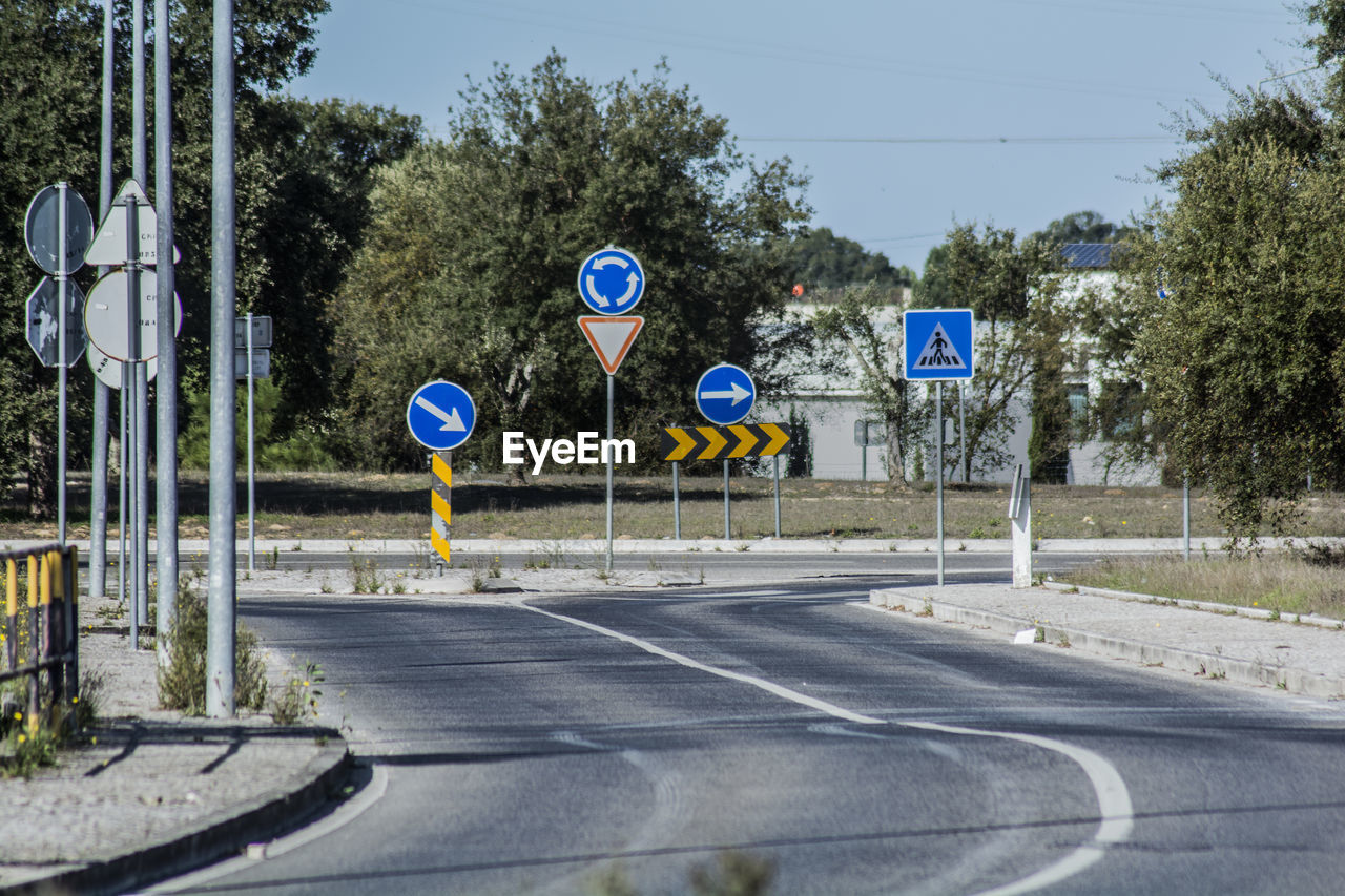 Road sign against trees