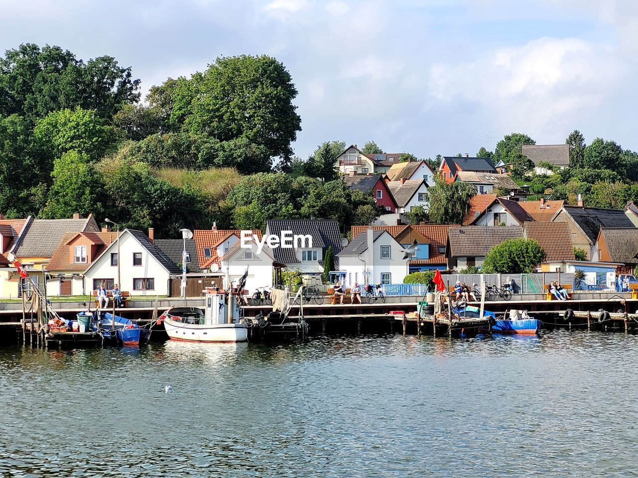 Houses by sea score and buildings against sky