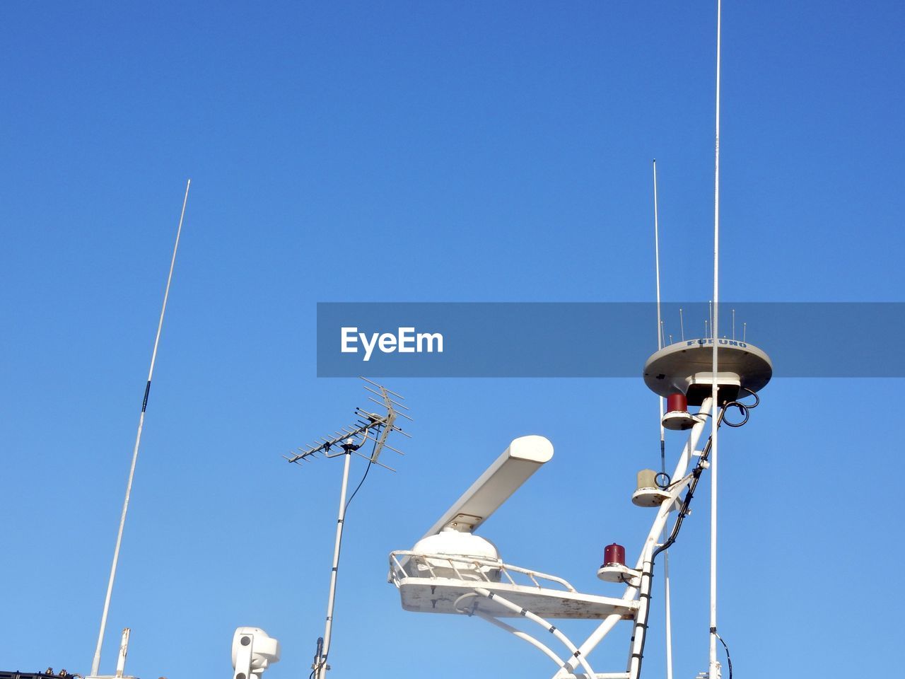 Low angle view of radar against clear blue sky