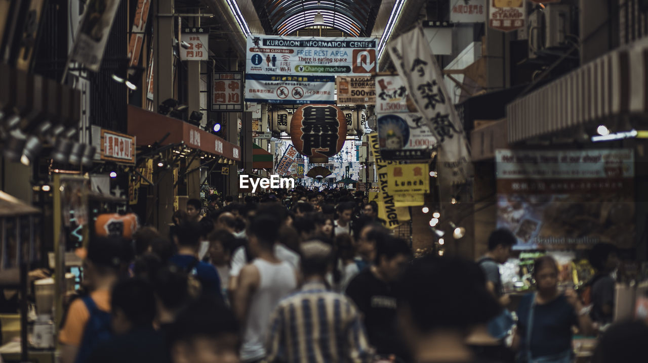 People on street amidst buildings in city