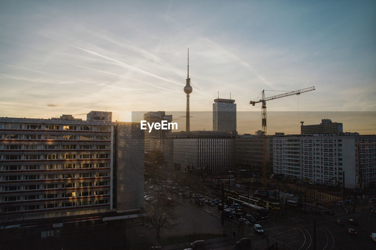 Fernsehturm tower with cityscape against sky during sunset