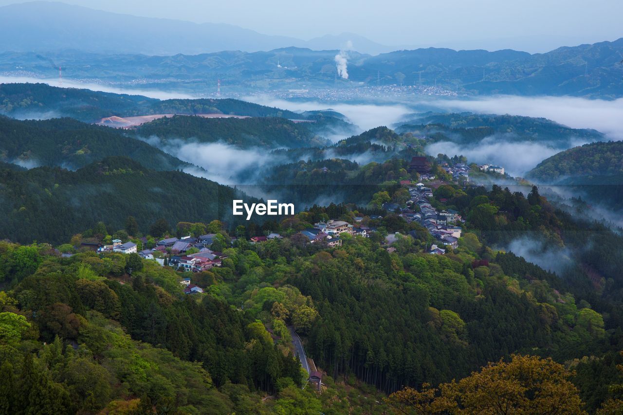 High angle view of trees and mountains against sky