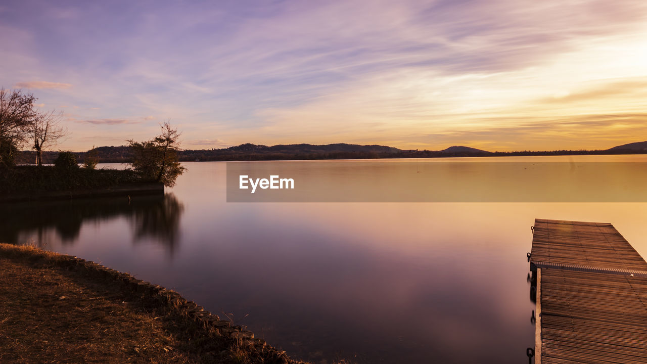 Scenic view of lake against sky during sunset