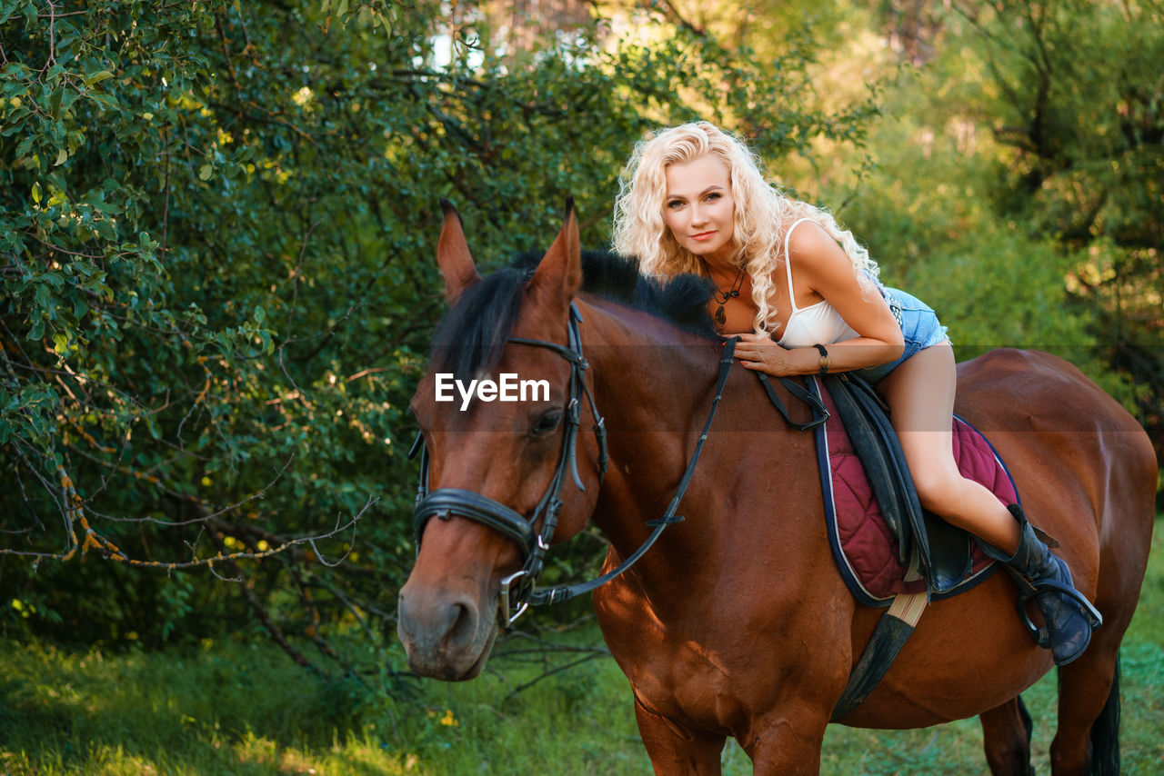 Portrait of woman riding horse