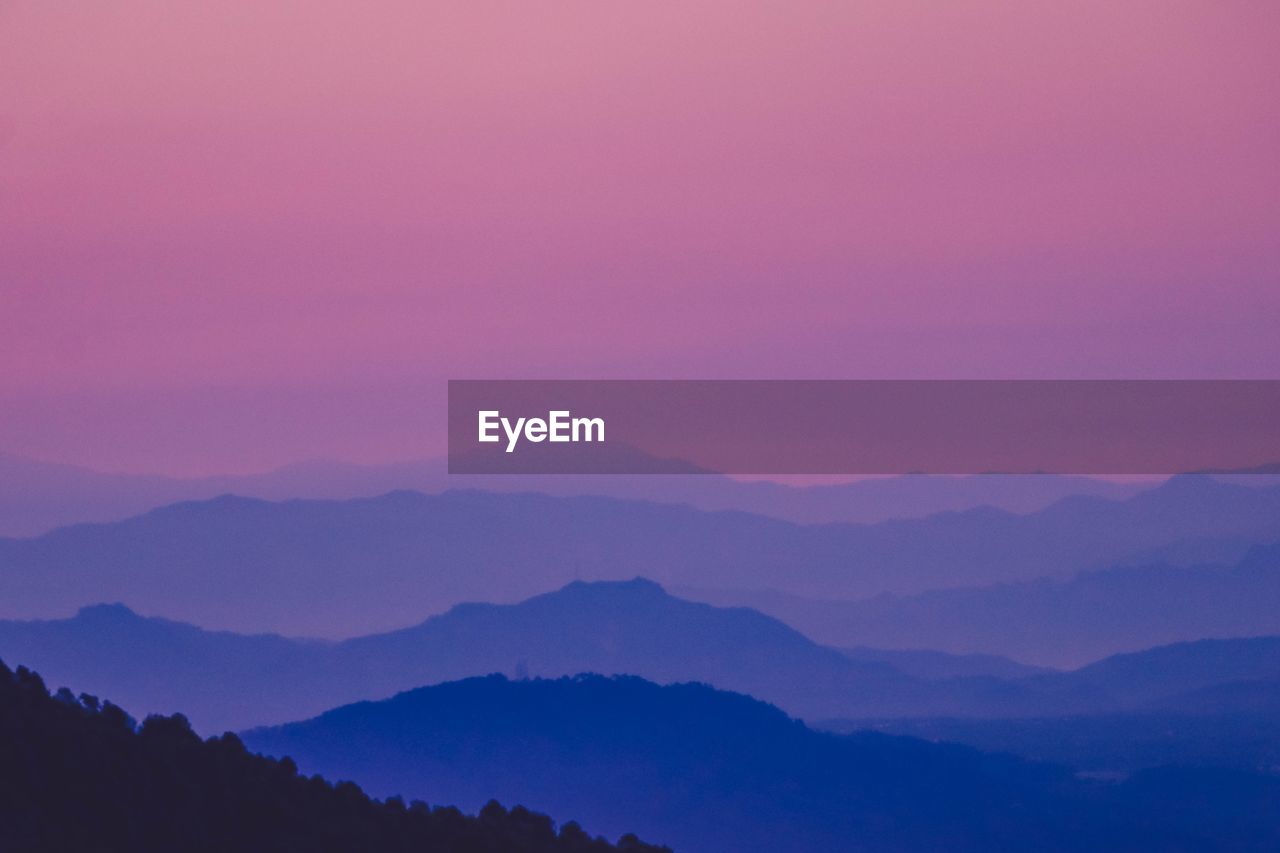 SCENIC VIEW OF MOUNTAINS AGAINST SKY DURING SUNSET