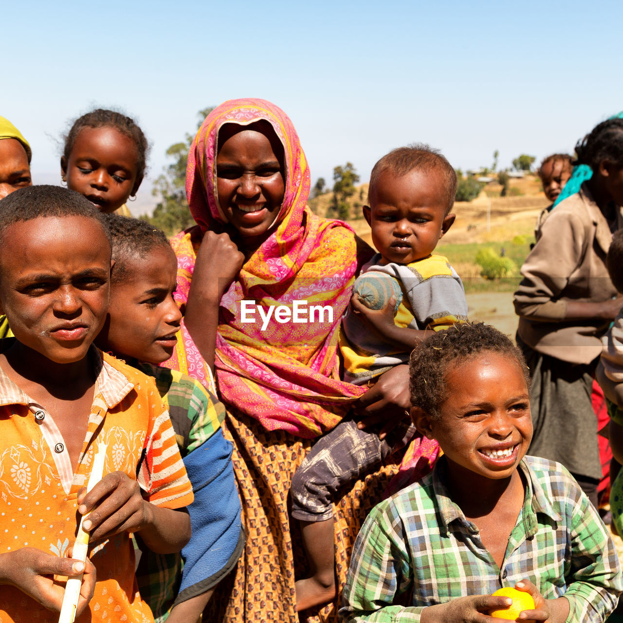 PORTRAIT OF SMILING BOY AND PEOPLE