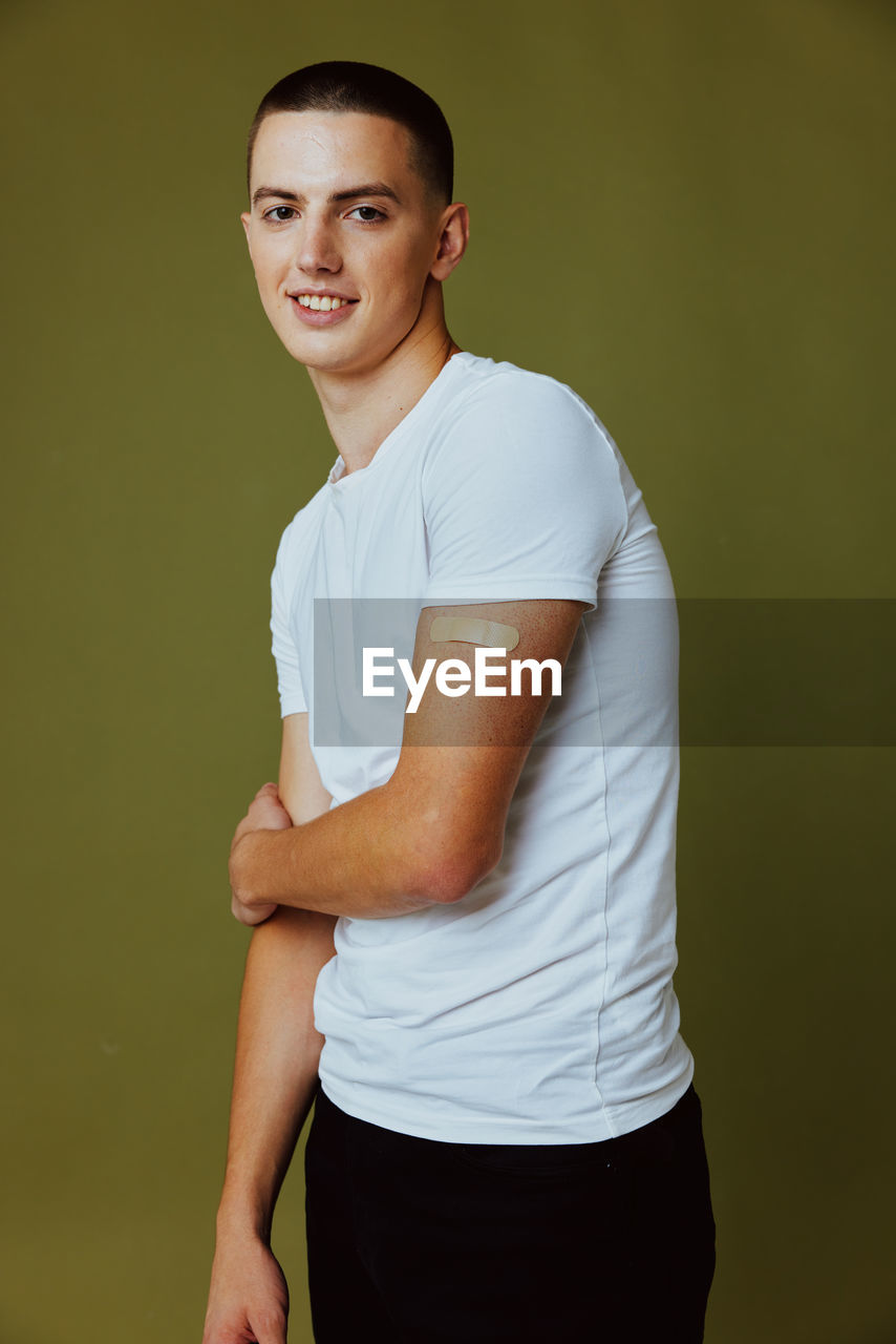 PORTRAIT OF A YOUNG MAN AGAINST WHITE BACKGROUND