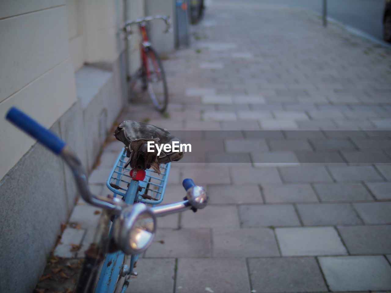 Close-up of bicycle on street in city