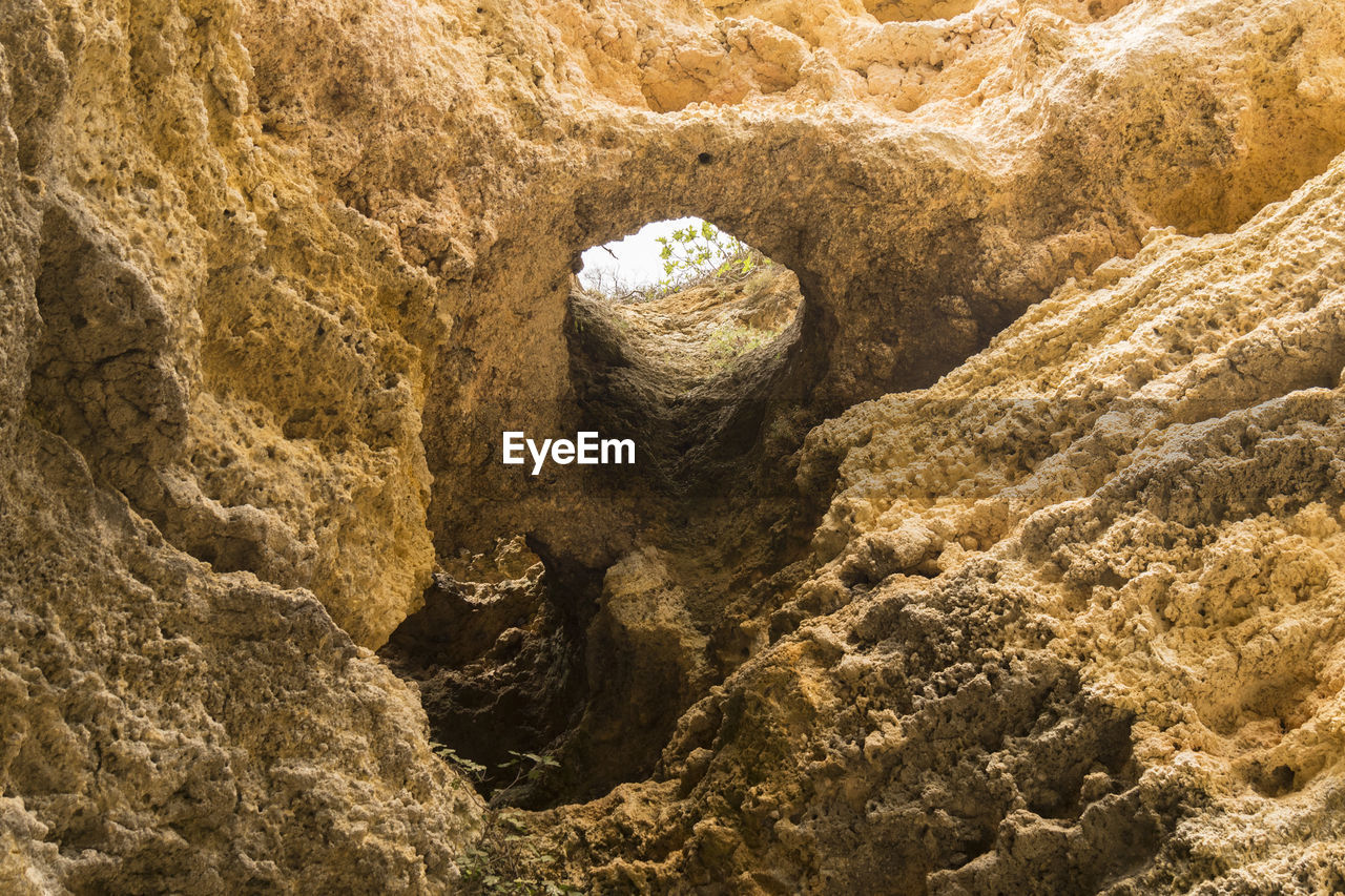 geology, rock, nature, land, no people, day, high angle view, sunlight, soil, ancient history, sand, outdoors, beach, wadi, rock formation, tranquility, formation, beauty in nature, textured