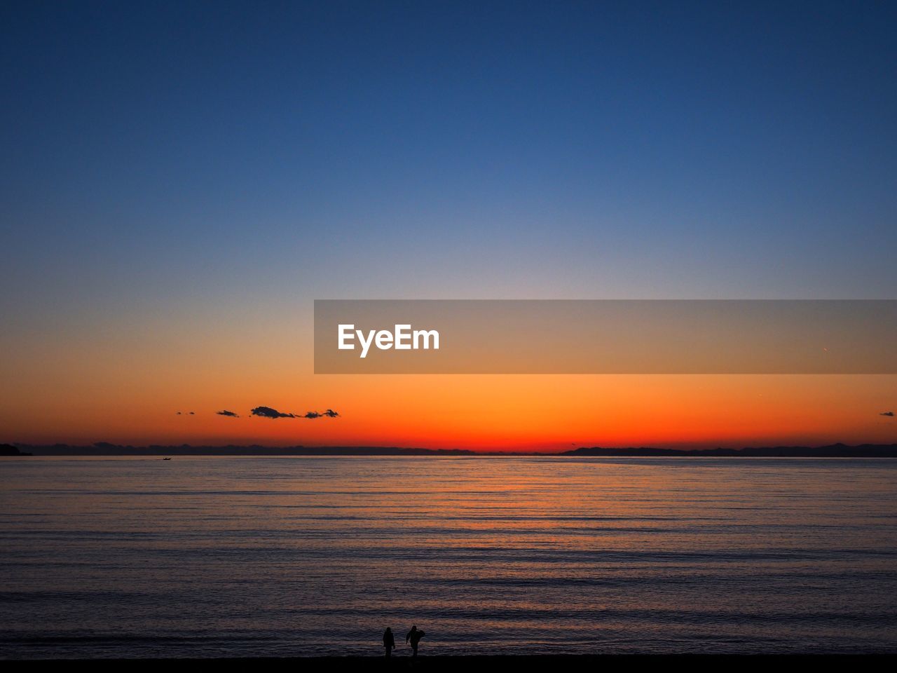 Scenic view of sea against clear sky during sunset