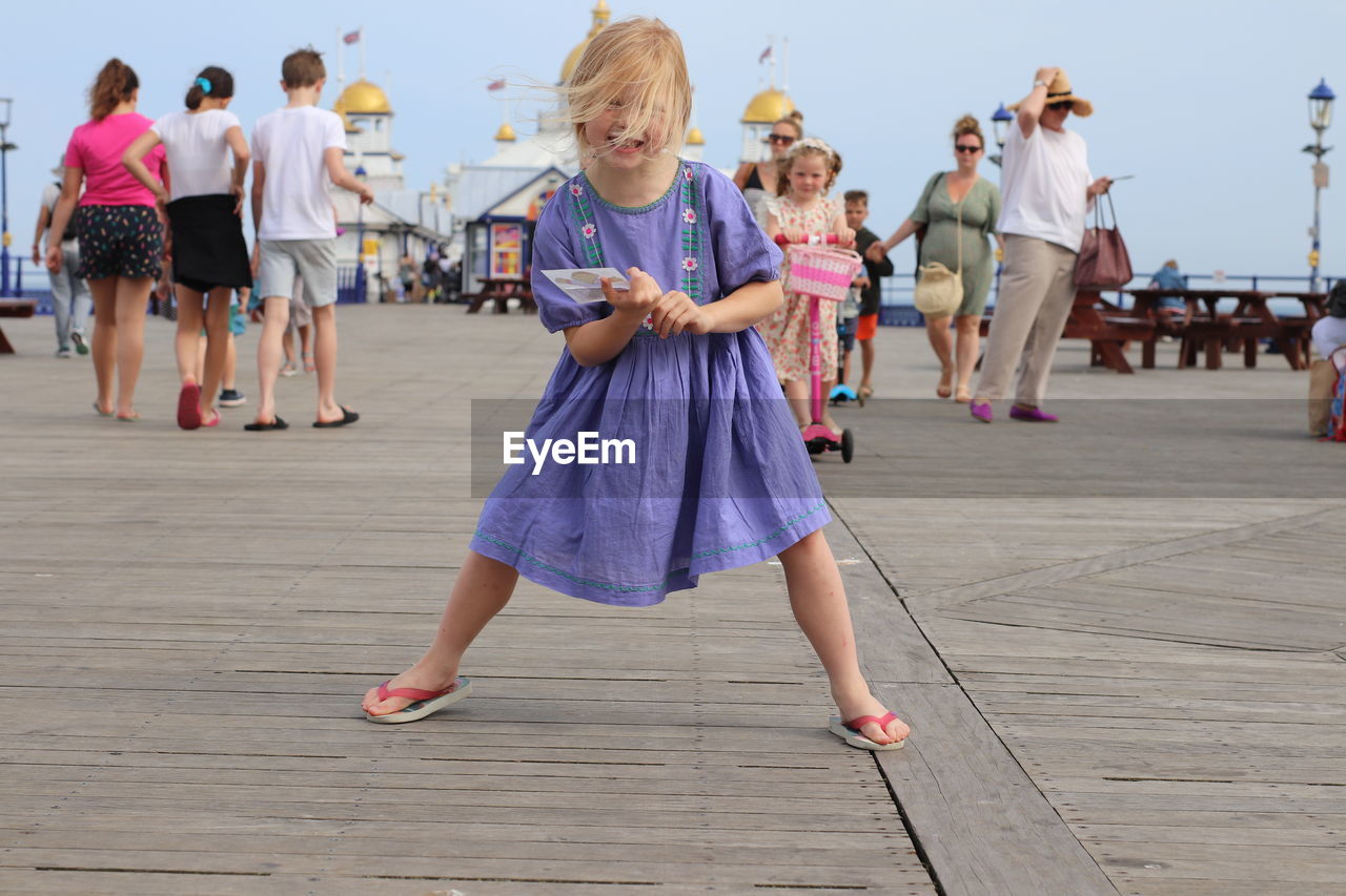 Girl standing on pier