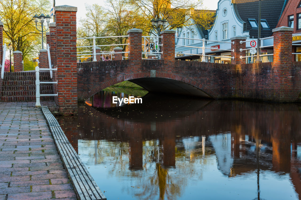 Reflection of trees and buildings in canal