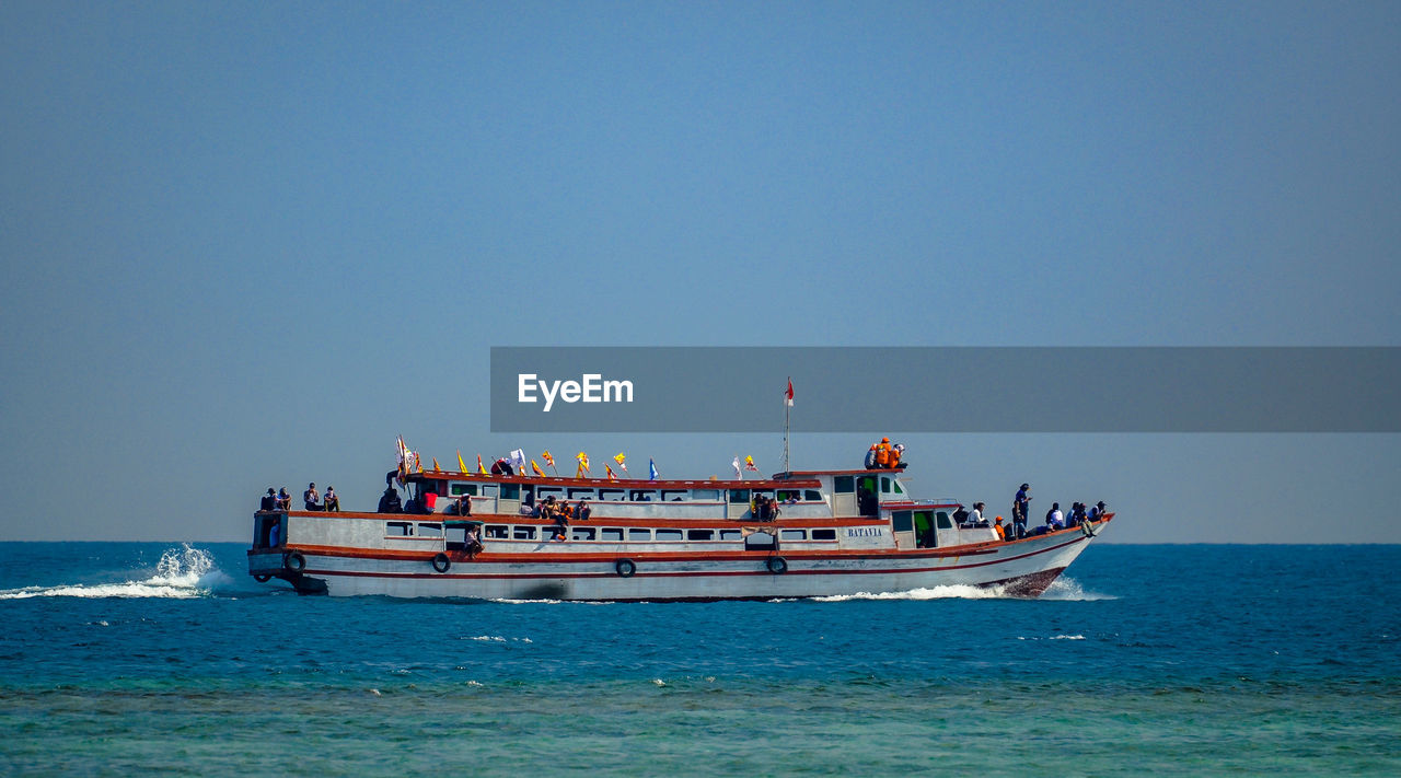 SHIP SAILING ON SEA AGAINST CLEAR SKY