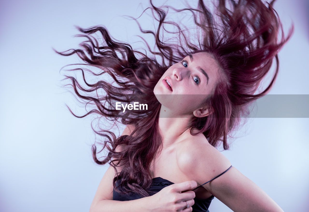 Young woman against blue background