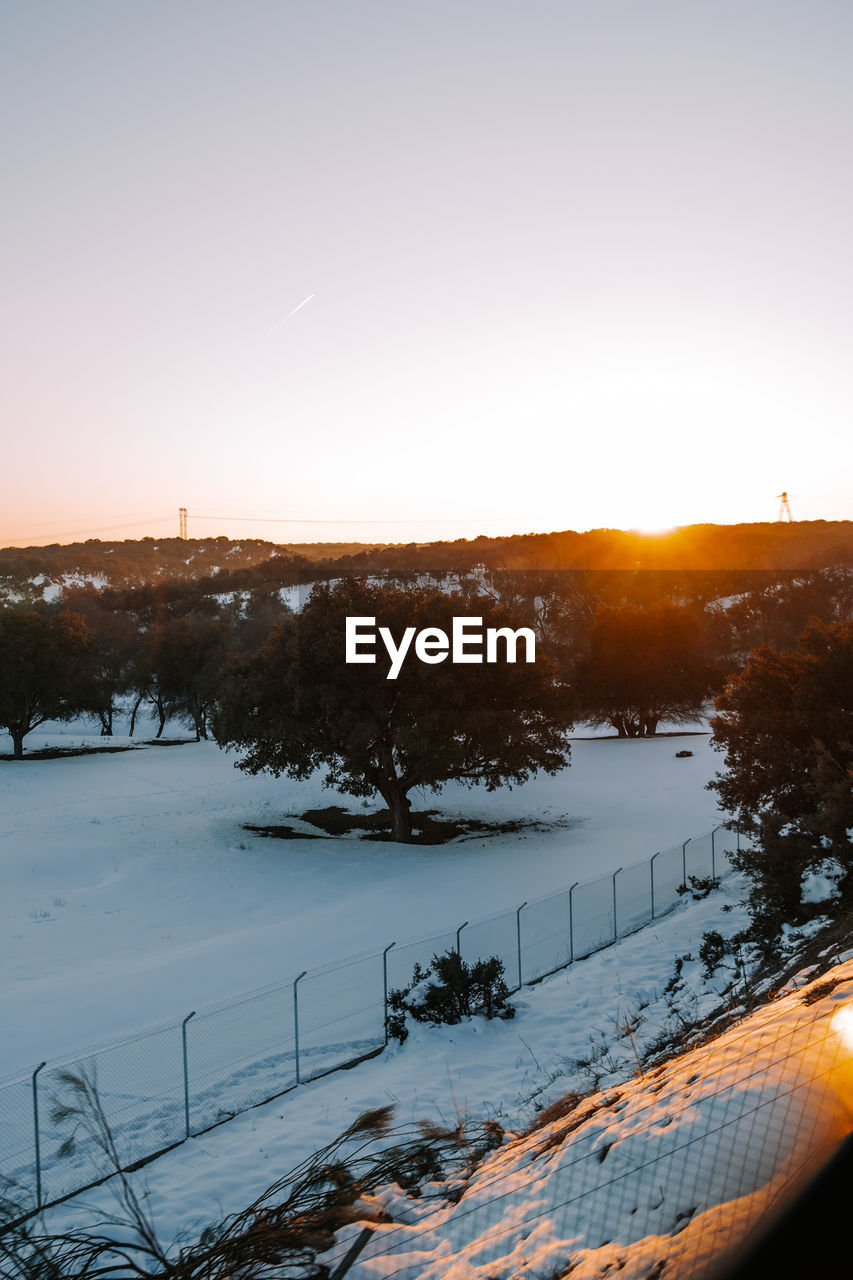 Vertical view of a beautiful snowy sunset from the train with a snowy forest. snow photo concept