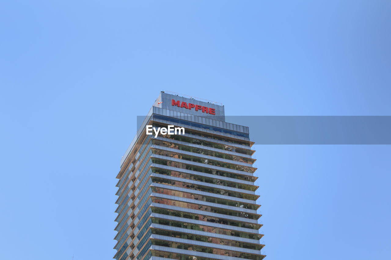 LOW ANGLE VIEW OF BUILDING AGAINST BLUE SKY