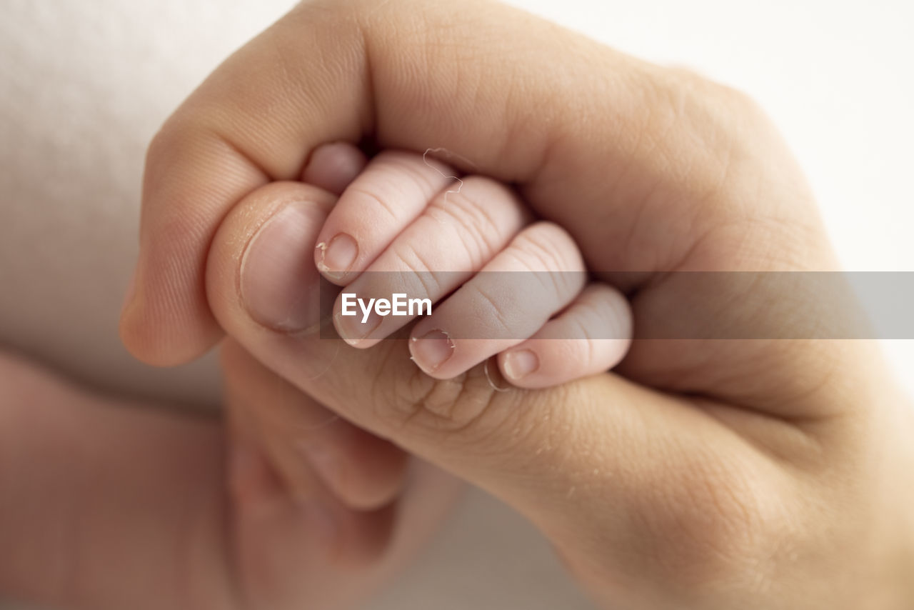 cropped image of baby on bed