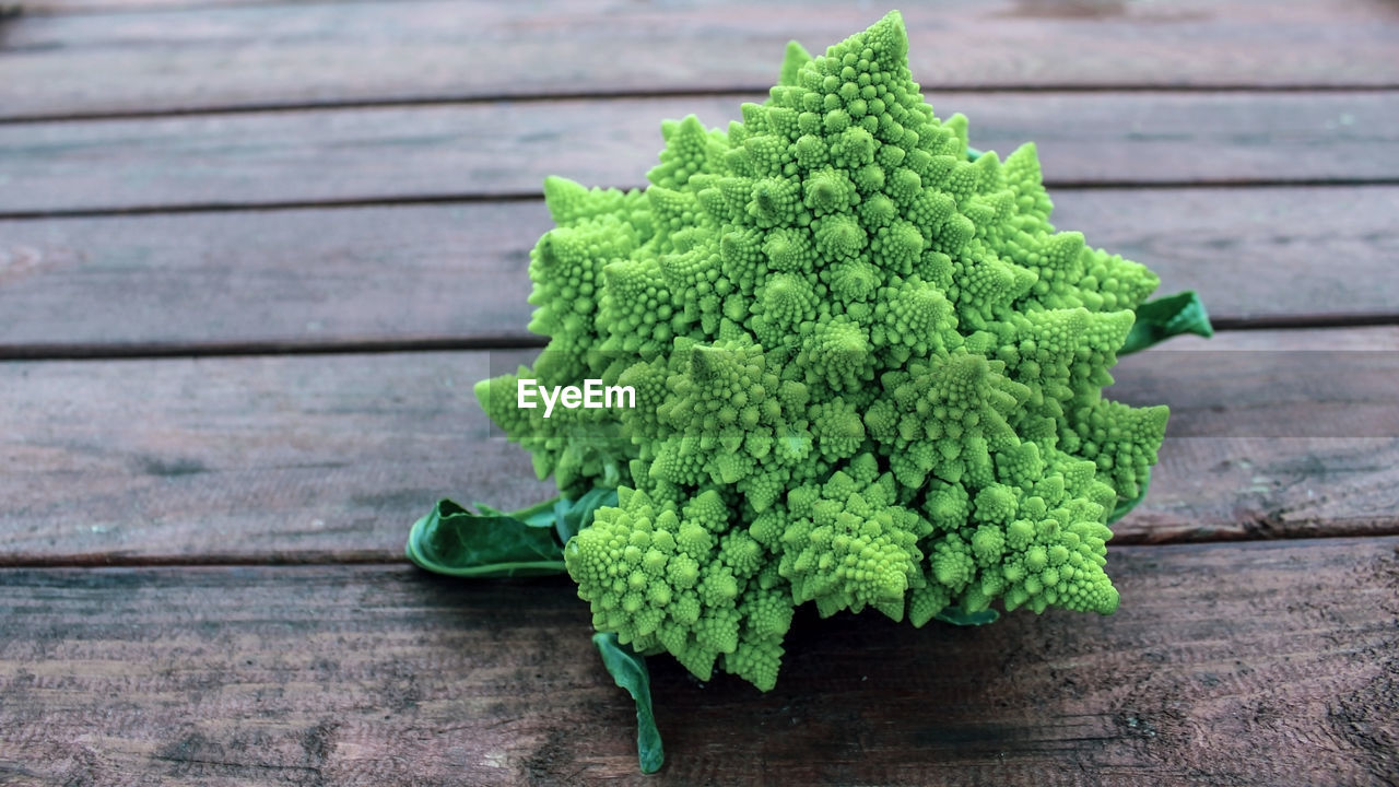 Romanesco cabbage on a wooden background. delicious fresh vegetables grown in an organic garden. 