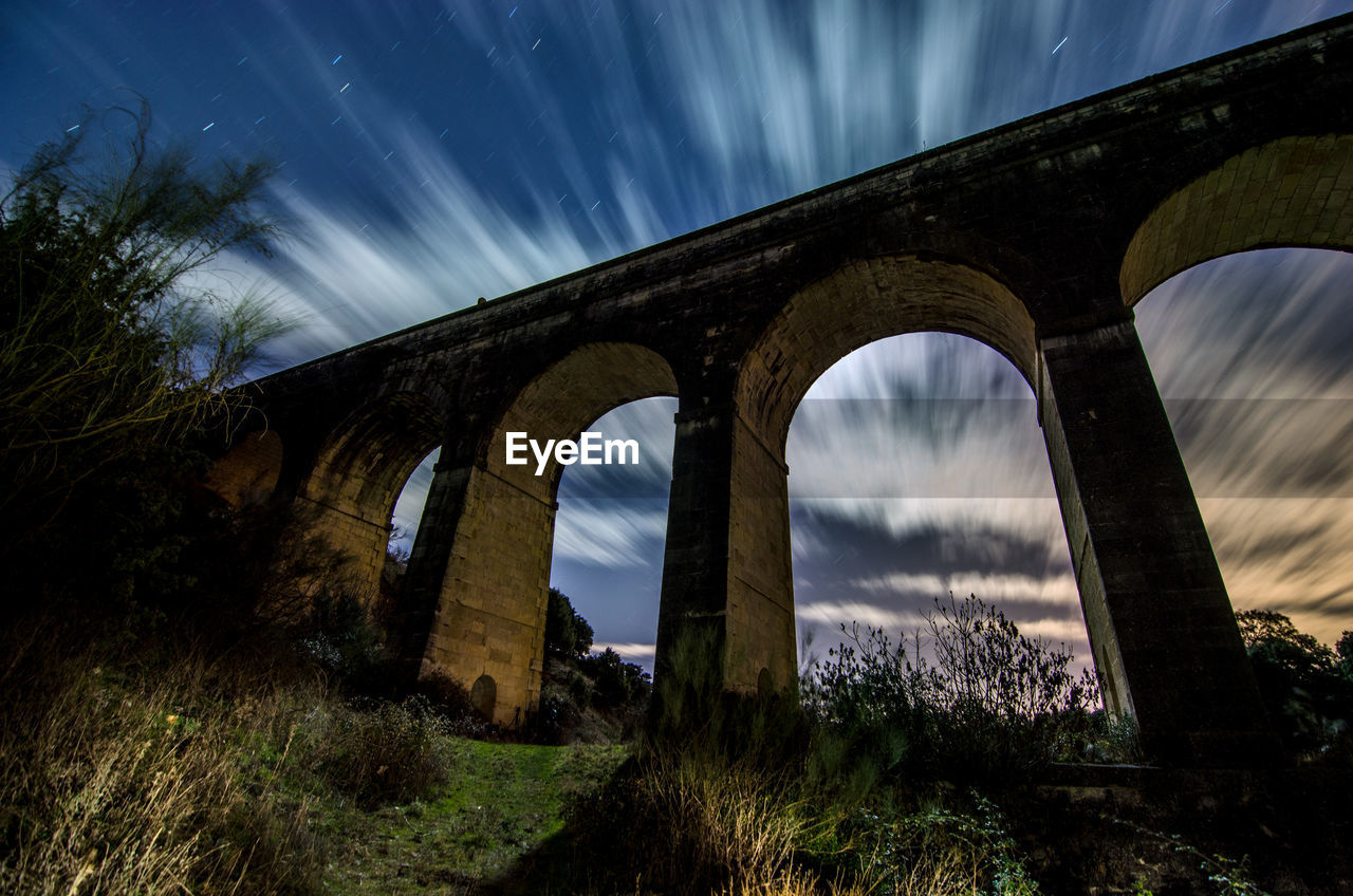 Low angle view of arch bridge against sky