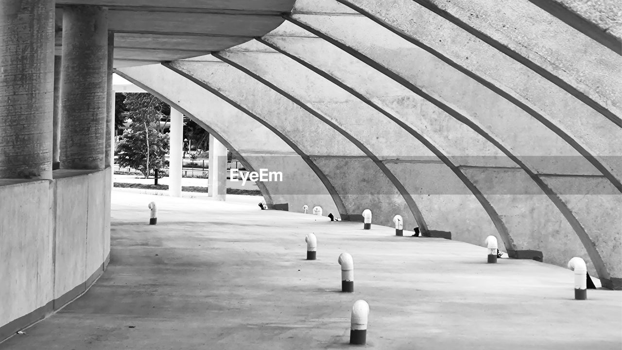 architecture, built structure, black and white, monochrome, arch, day, monochrome photography, transportation, architectural column, line, white, infrastructure, group of people, subway, building exterior, city, outdoors, travel, ceiling, men