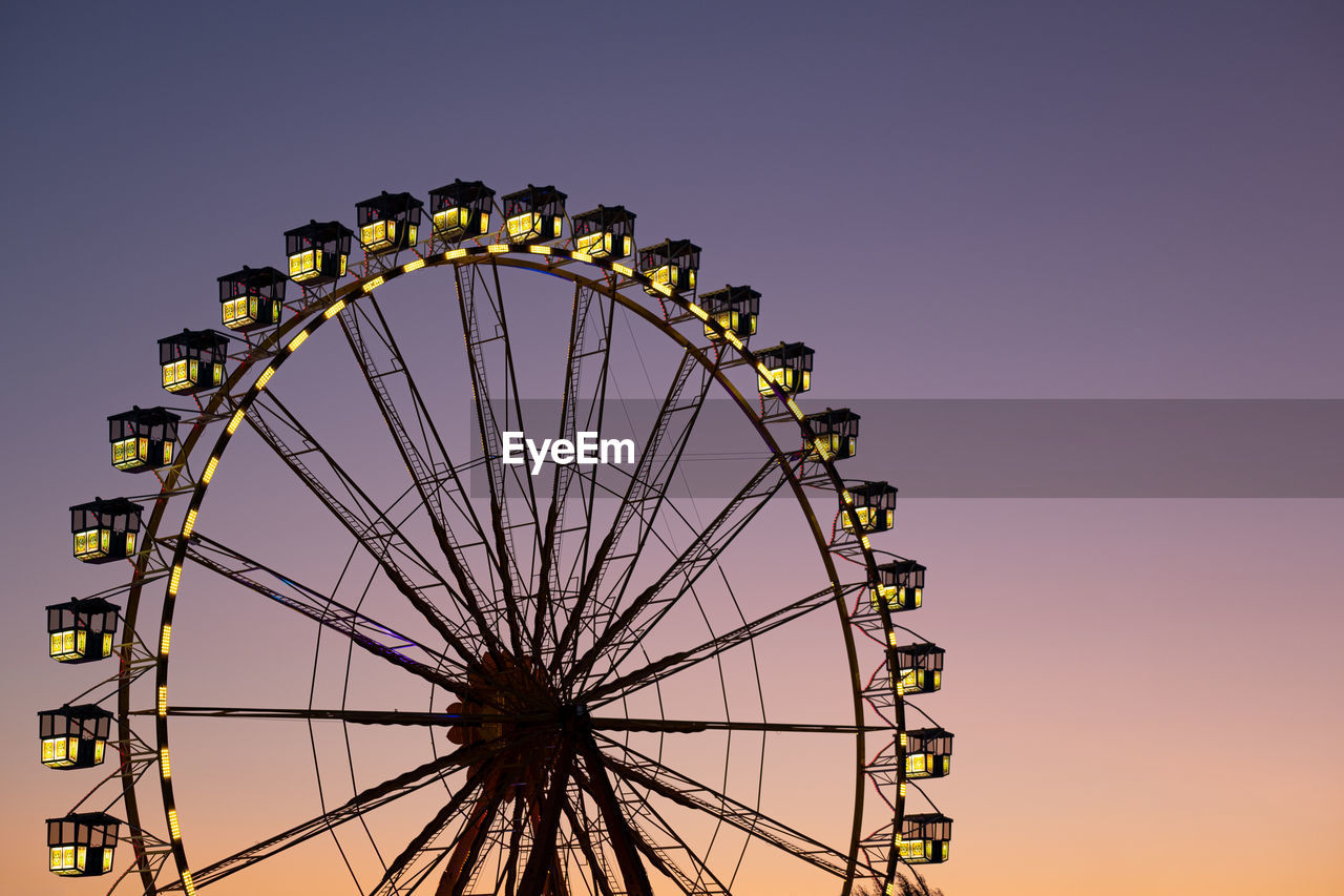 Ferris wheel against sunset