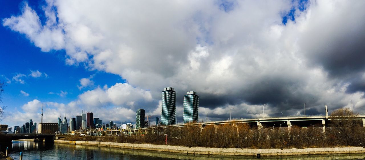 Buildings against cloudy sky