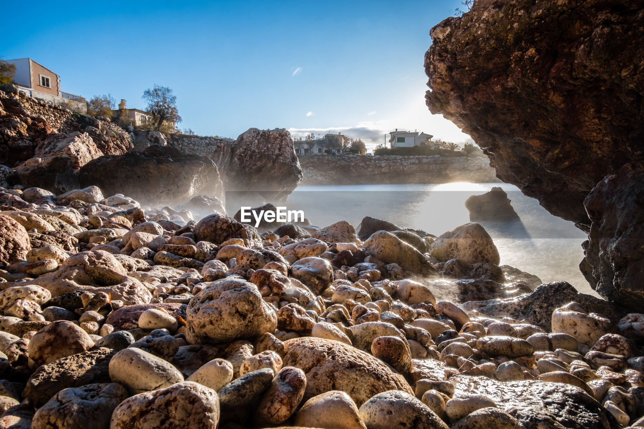 SCENIC VIEW OF ROCKS IN SEA AGAINST SKY