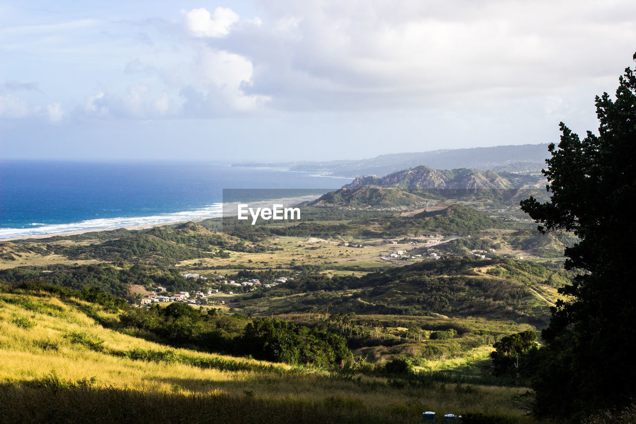 Scenic view of landscape and sea against sky