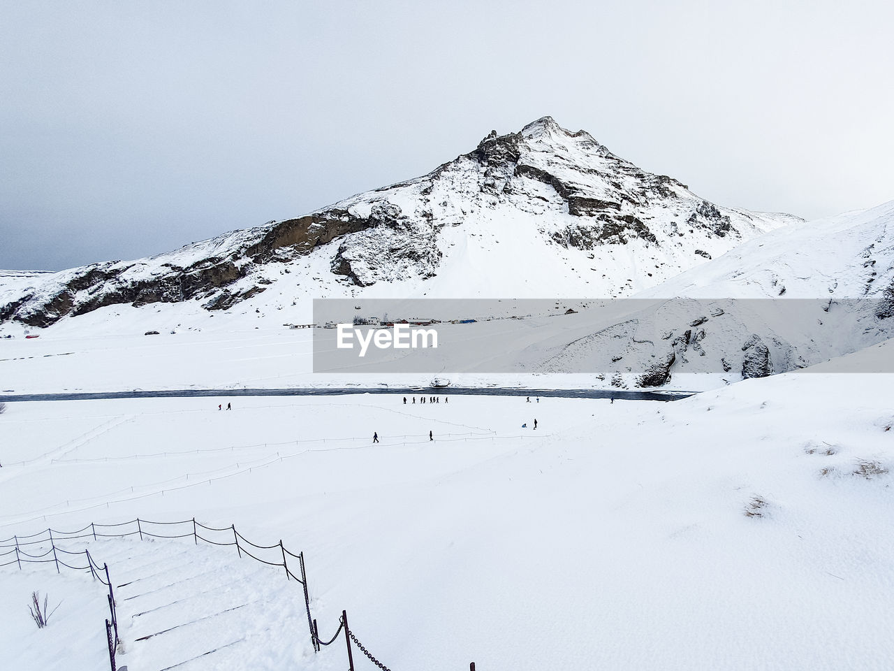 SNOW COVERED MOUNTAINS AGAINST SKY