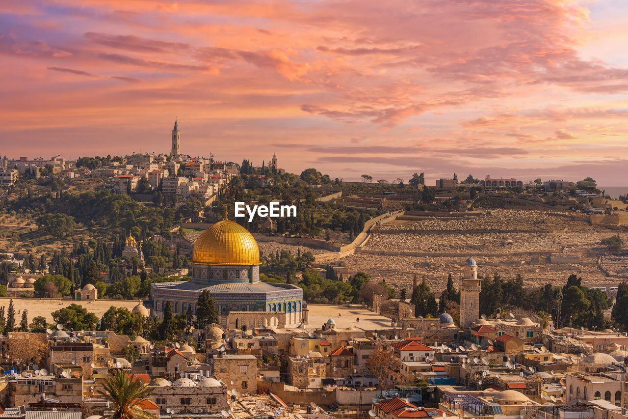 Sunset view of jerusalem dominated by golden cupola of the dome of the rock