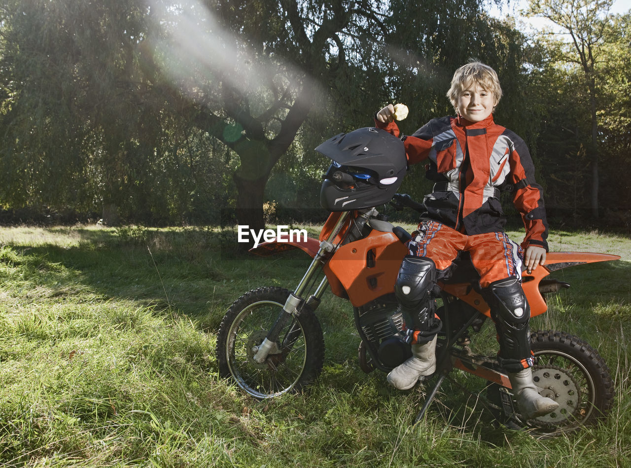 12 year old boy having a break on his off road motorbike