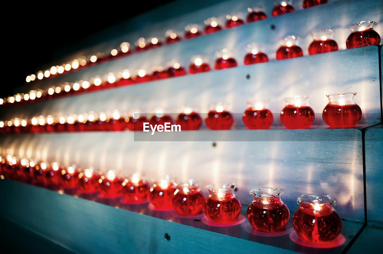 Lit tea light candles in shelves