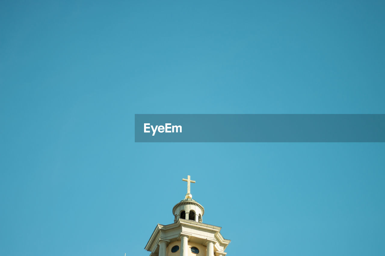 Low angle view of church against clear blue sky