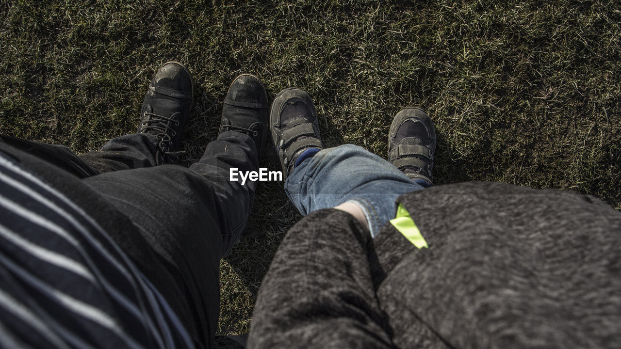Low section of men standing on field